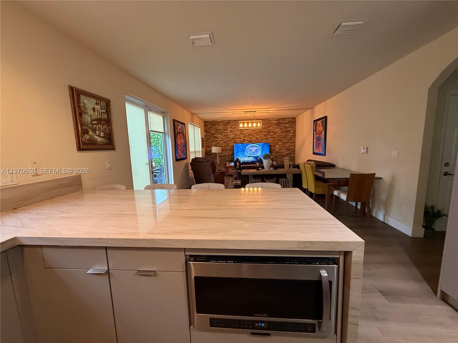 17012 Southwest 91st Street Miami, FL 33196 - Photo 3 of 22 a kitchen with stainless steel appliances a stove microwave and refrigerator