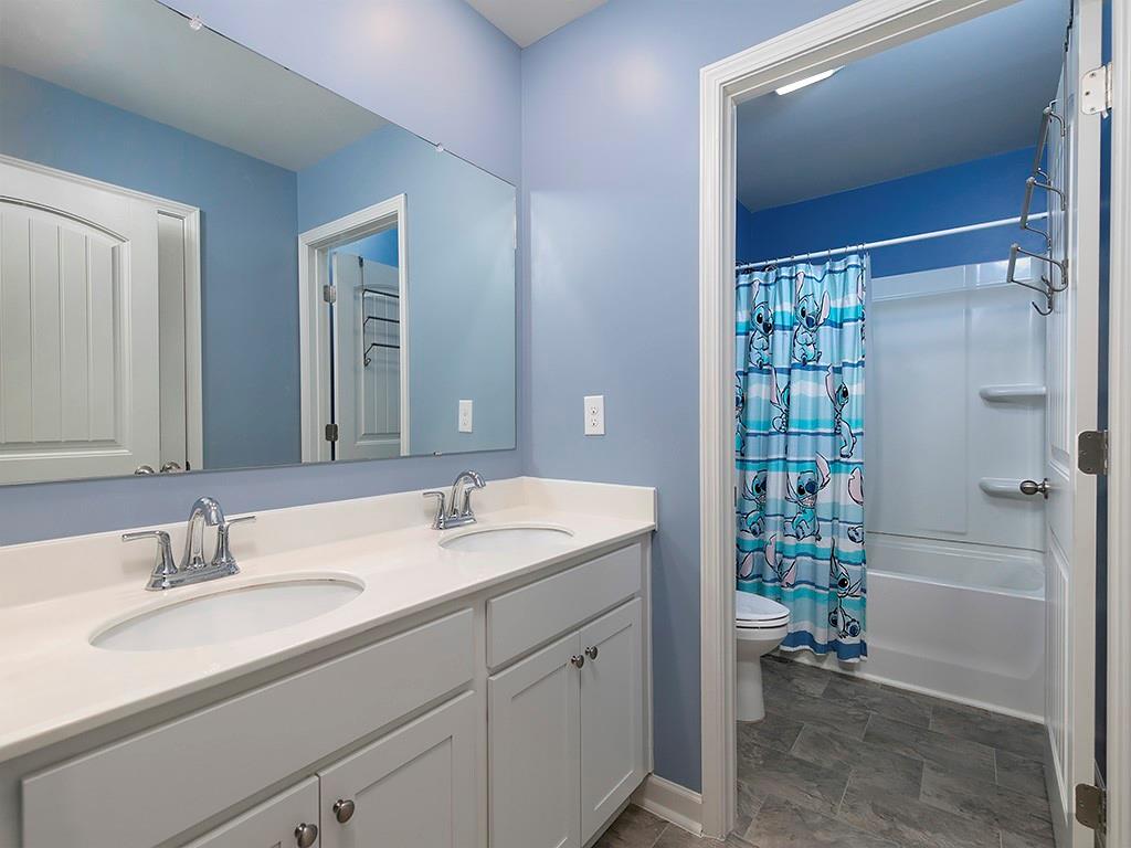 371 Highgrove Circle Dallas, GA 30157 - Photo 17 of 20 a bathroom with a sink a toilet and shower
