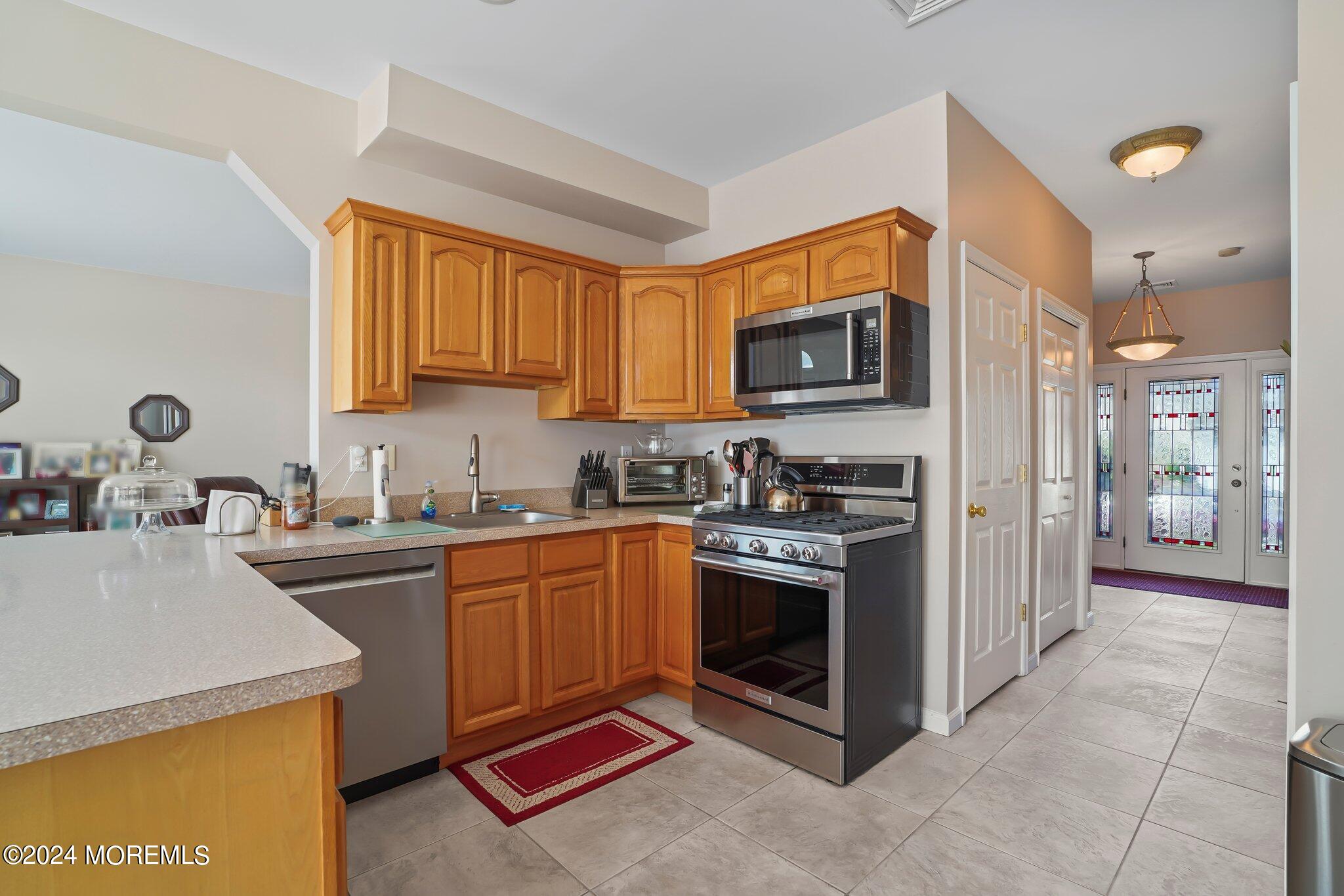 4 Anderson Street Union Beach, NJ 07735 - Photo 14 of 51 a kitchen with stainless steel appliances granite countertop a stove a sink and a microwave