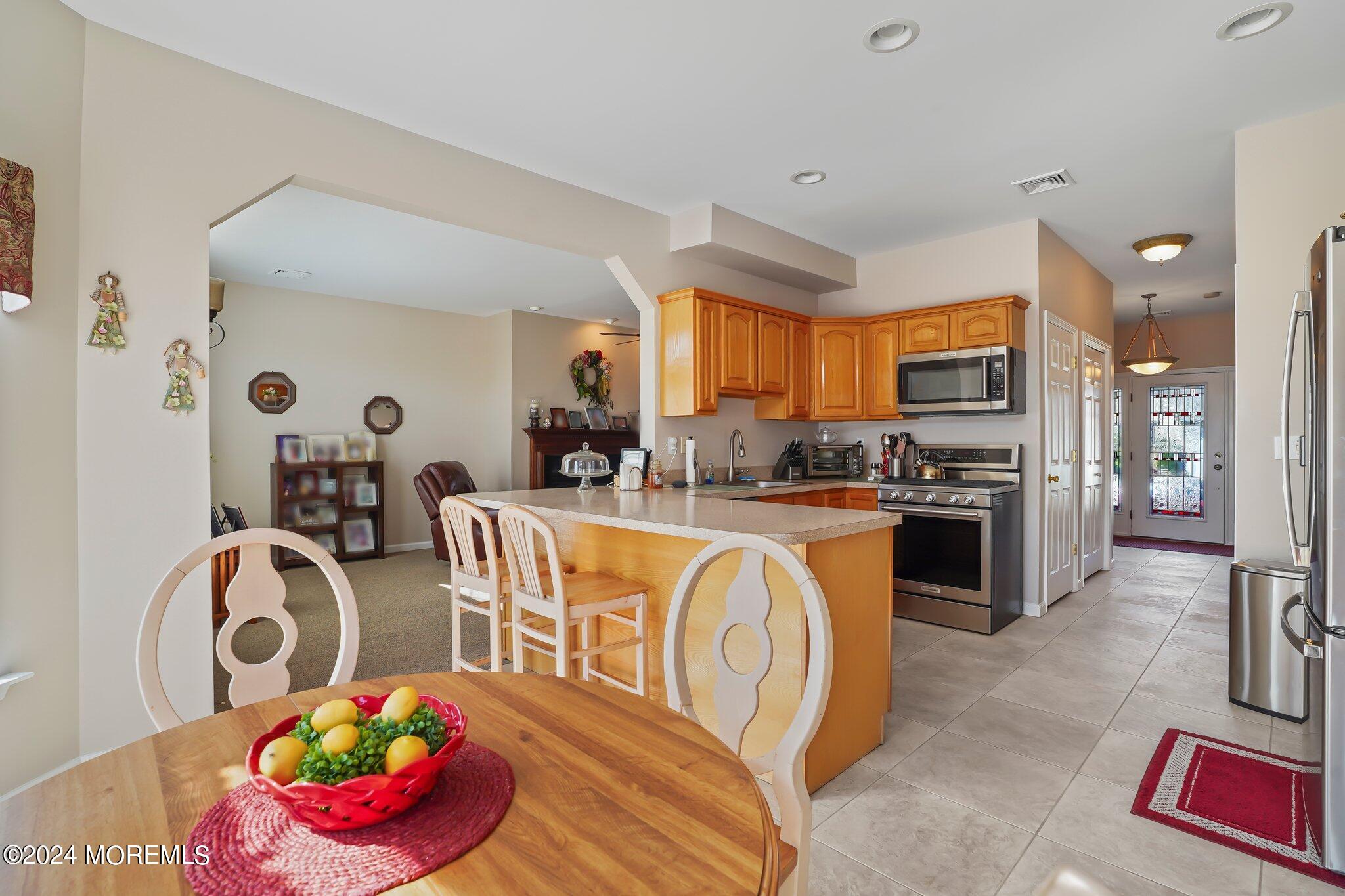 4 Anderson Street Union Beach, NJ 07735 - Photo 15 of 51 a kitchen with stainless steel appliances granite countertop a stove top oven a sink dishwasher and cabinets with wooden floor