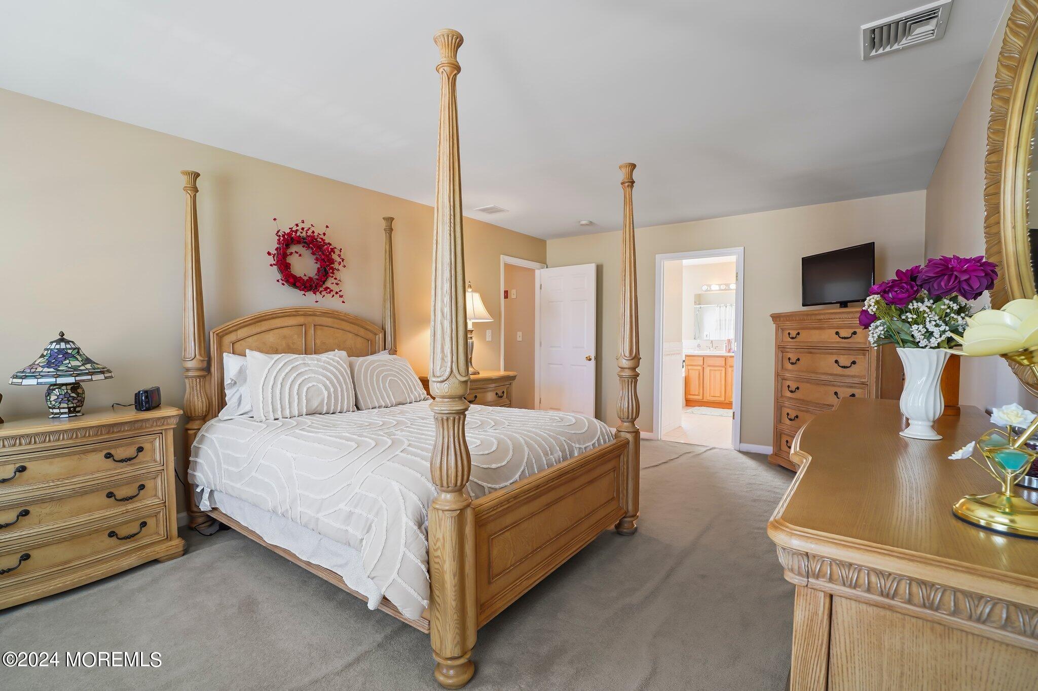 4 Anderson Street Union Beach, NJ 07735 - Photo 27 of 51 a spacious bedroom with a bed and a chandelier