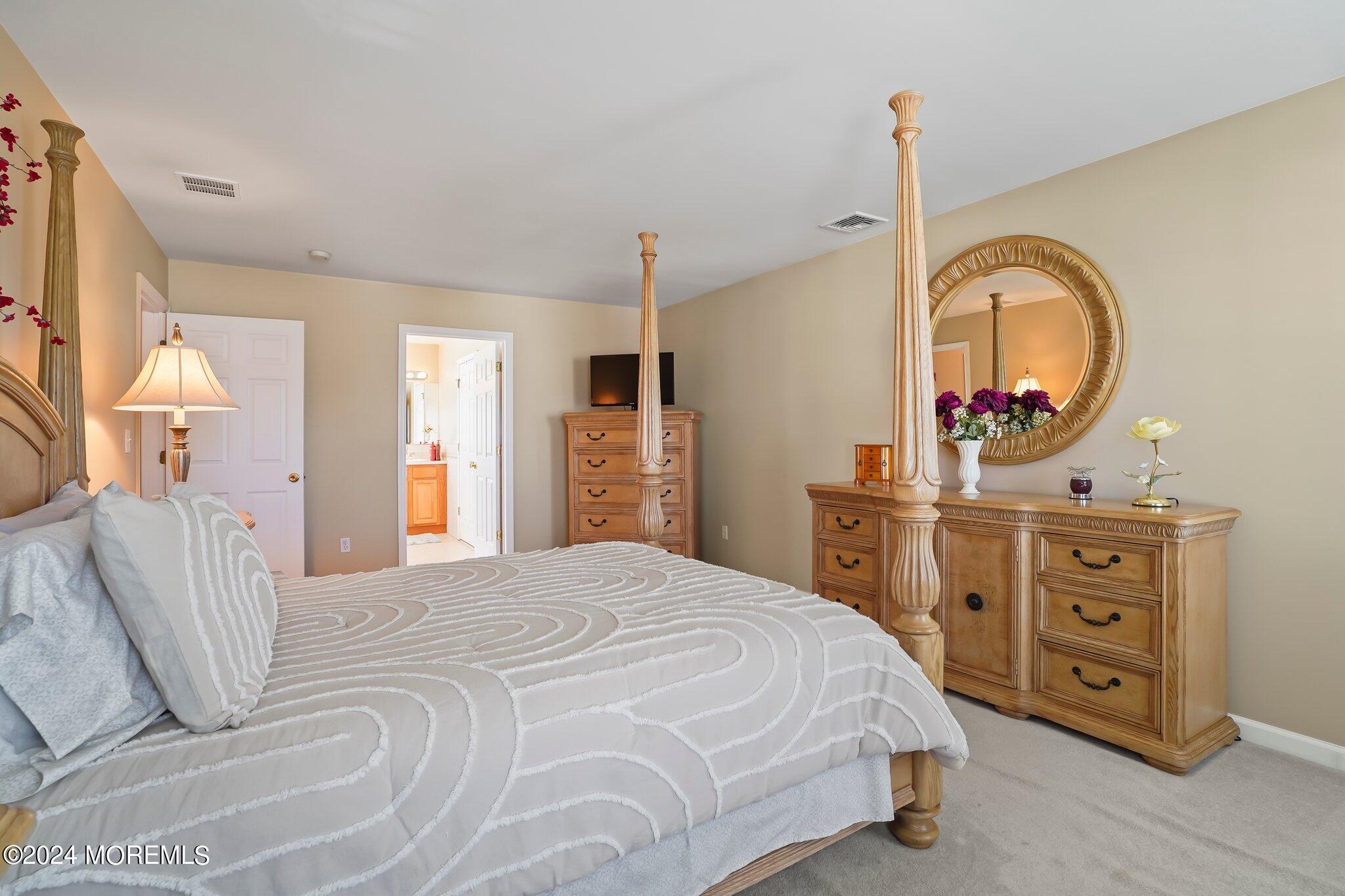 4 Anderson Street Union Beach, NJ 07735 - Photo 28 of 51 a bedroom with a bed a mirror and dresser