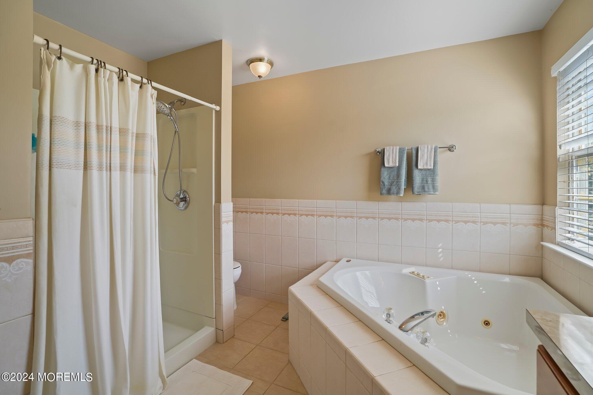 4 Anderson Street Union Beach, NJ 07735 - Photo 32 of 51 a bathroom with a bath tub and a shower
