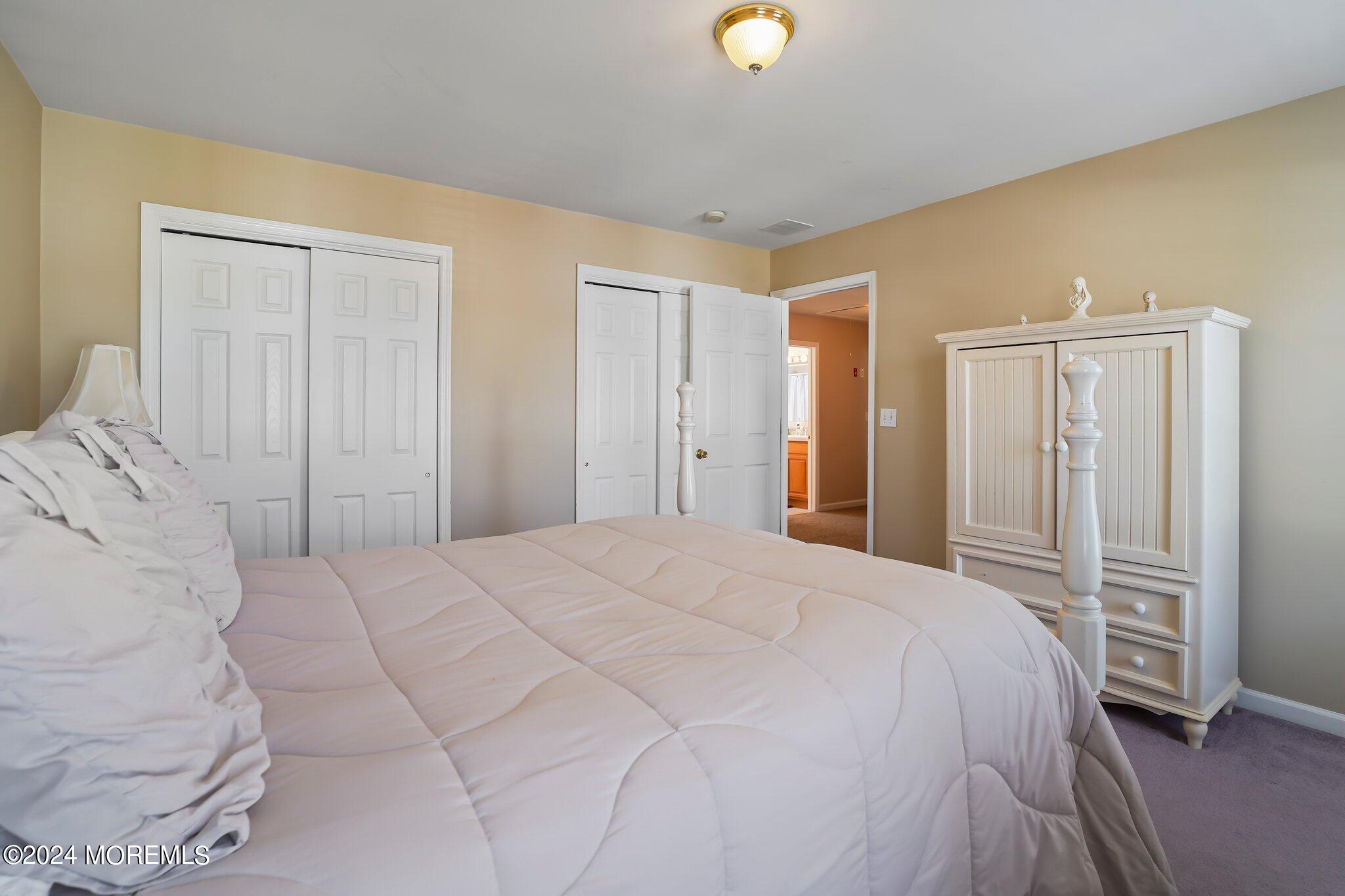 4 Anderson Street Union Beach, NJ 07735 - Photo 35 of 51 a spacious bedroom with a bed and cabinets