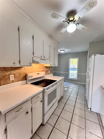 a kitchen with a stove a sink and a refrigerator