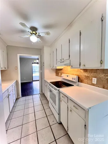 a kitchen with a sink cabinets and window