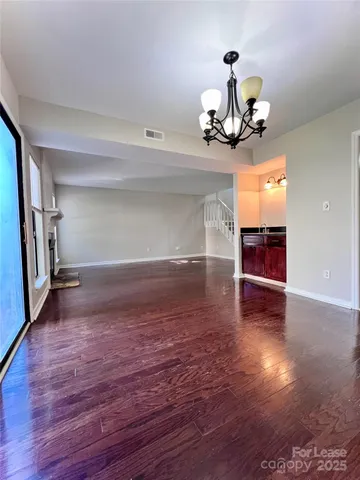 a view of a room with wooden floor