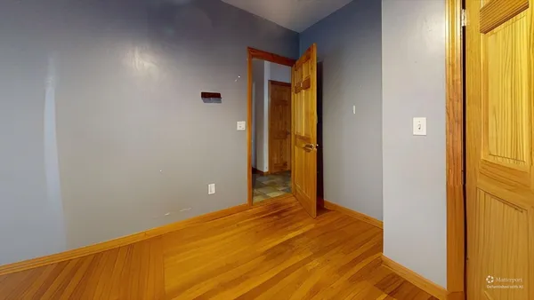a view of a room with wooden floor
