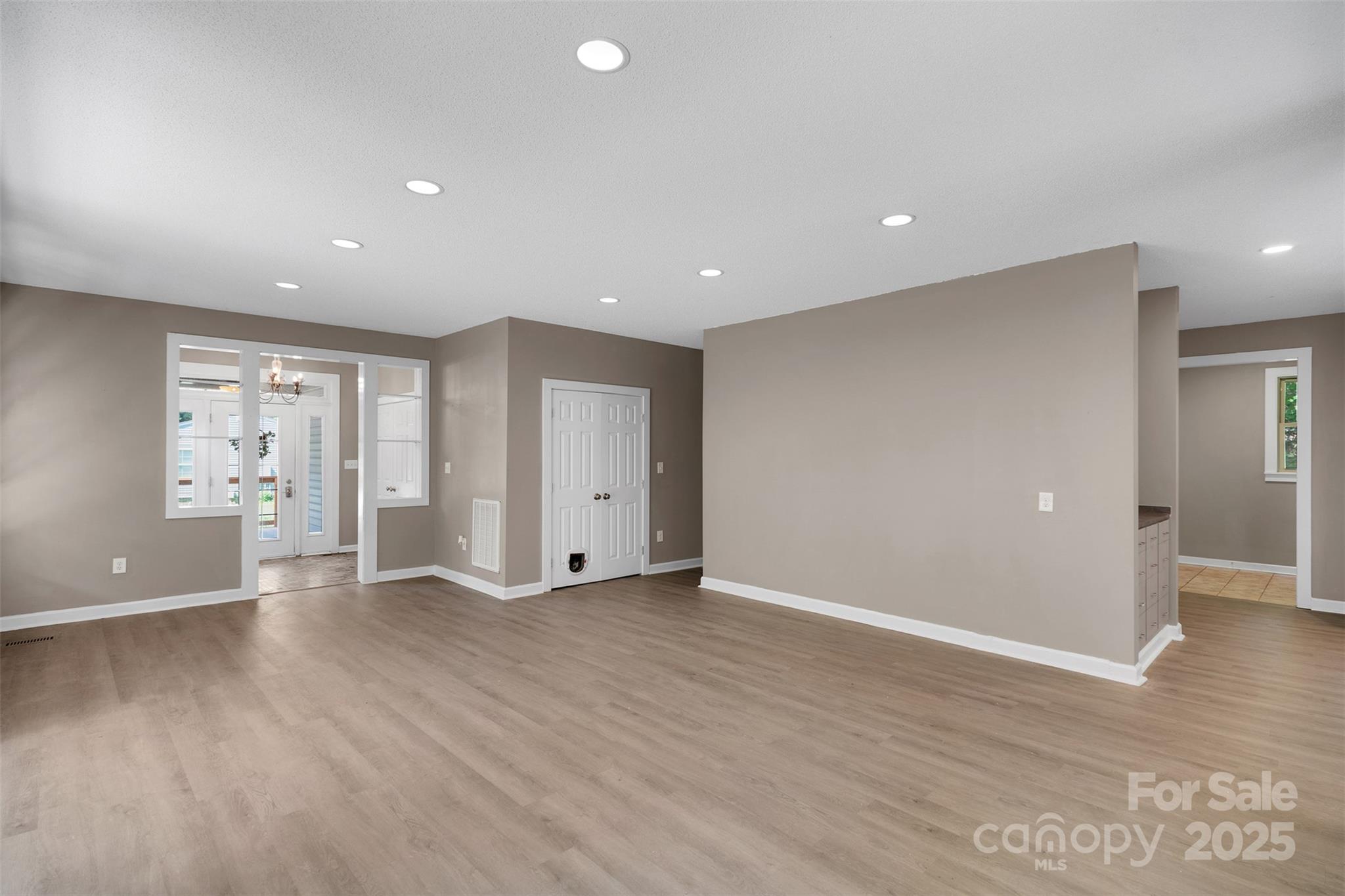 3333 Roberta Road Concord, NC 28027 - Photo 11 of 47 an empty room with wooden floor and windows