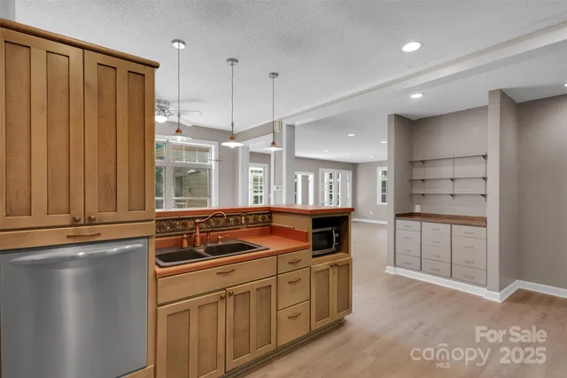 a kitchen with a refrigerator and white cabinets