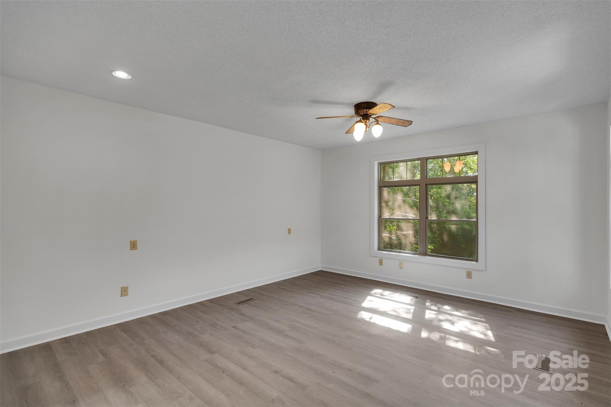 3333 Roberta Road Concord, NC 28027 - Photo 21 of 47 an empty room with windows and ceiling fan