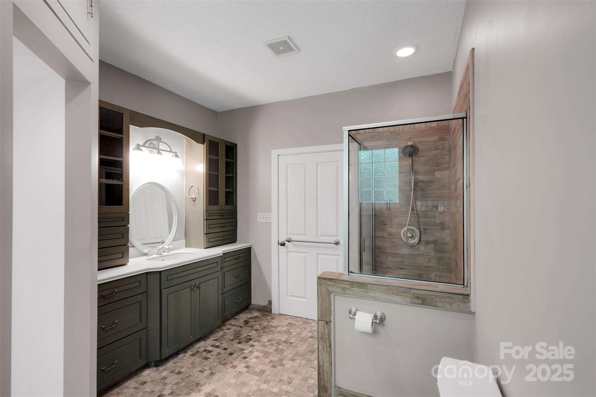 3333 Roberta Road Concord, NC 28027 - Photo 25 of 47 a bathroom with a double vanity sink mirror and shower