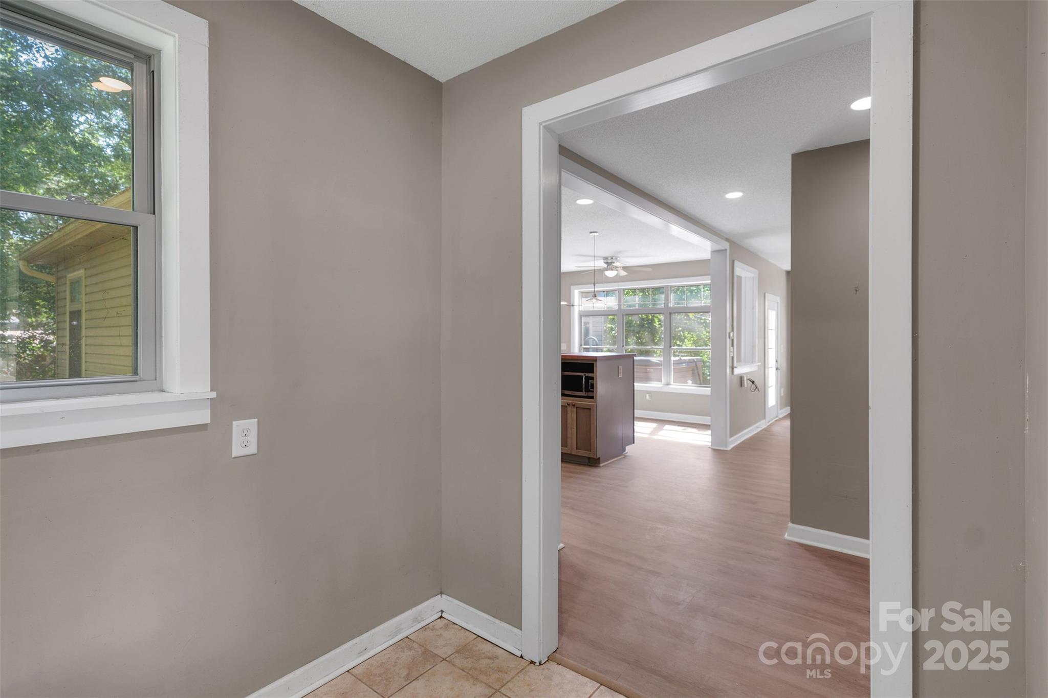 3333 Roberta Road Concord, NC 28027 - Photo 29 of 47 a view of a hallway with wooden floor and a living room