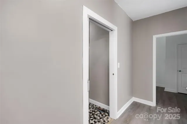 a view of a house with large trees plants and large tree