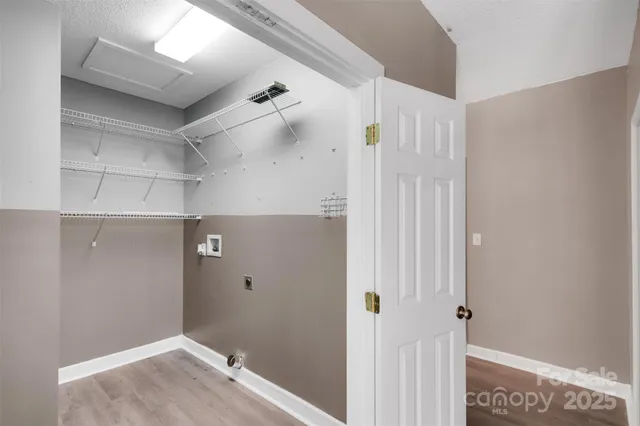 a backyard of a building with lots of flowers and trees