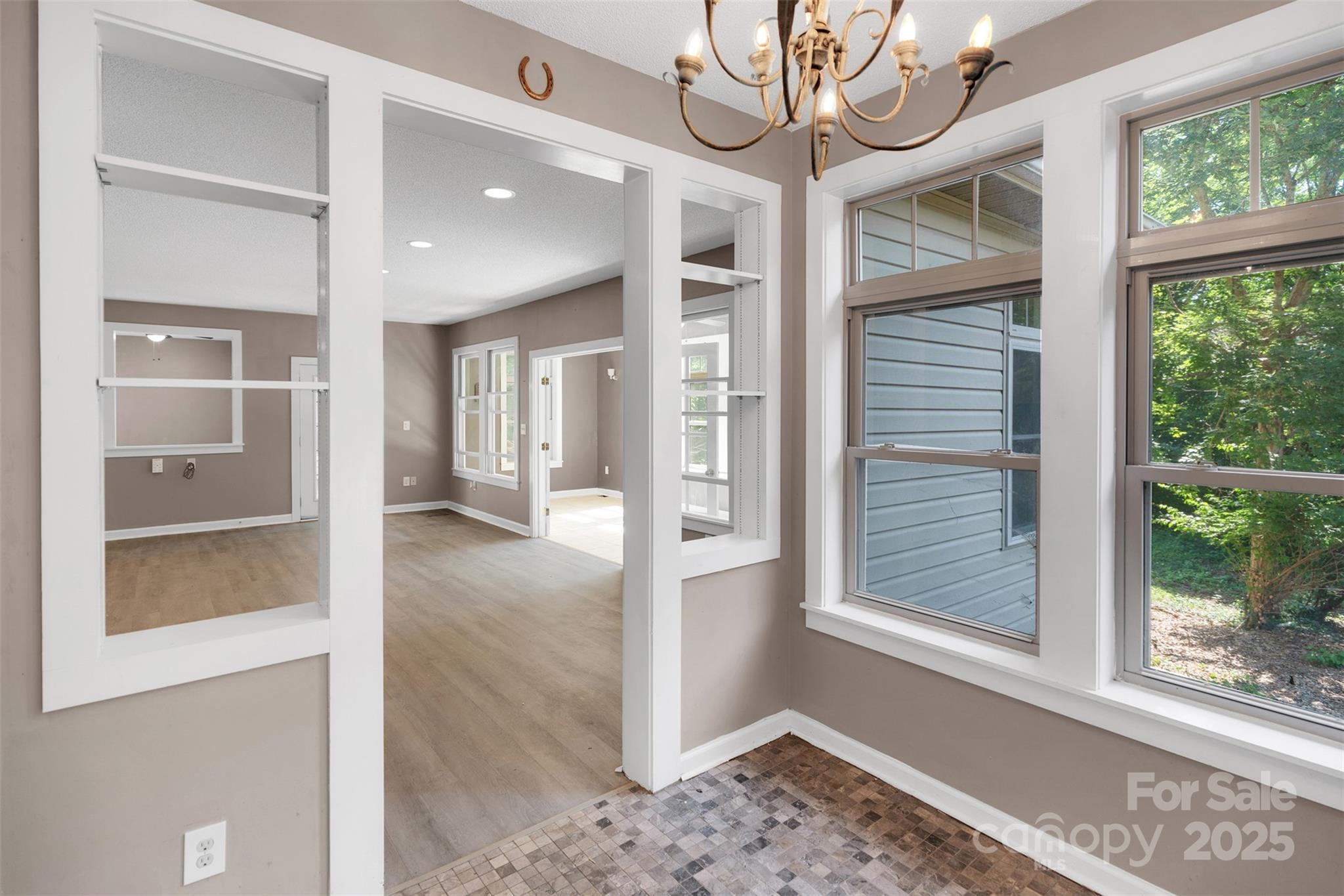 3333 Roberta Road Concord, NC 28027 - Photo 7 of 47 a view of a hallway with windows and chandelier