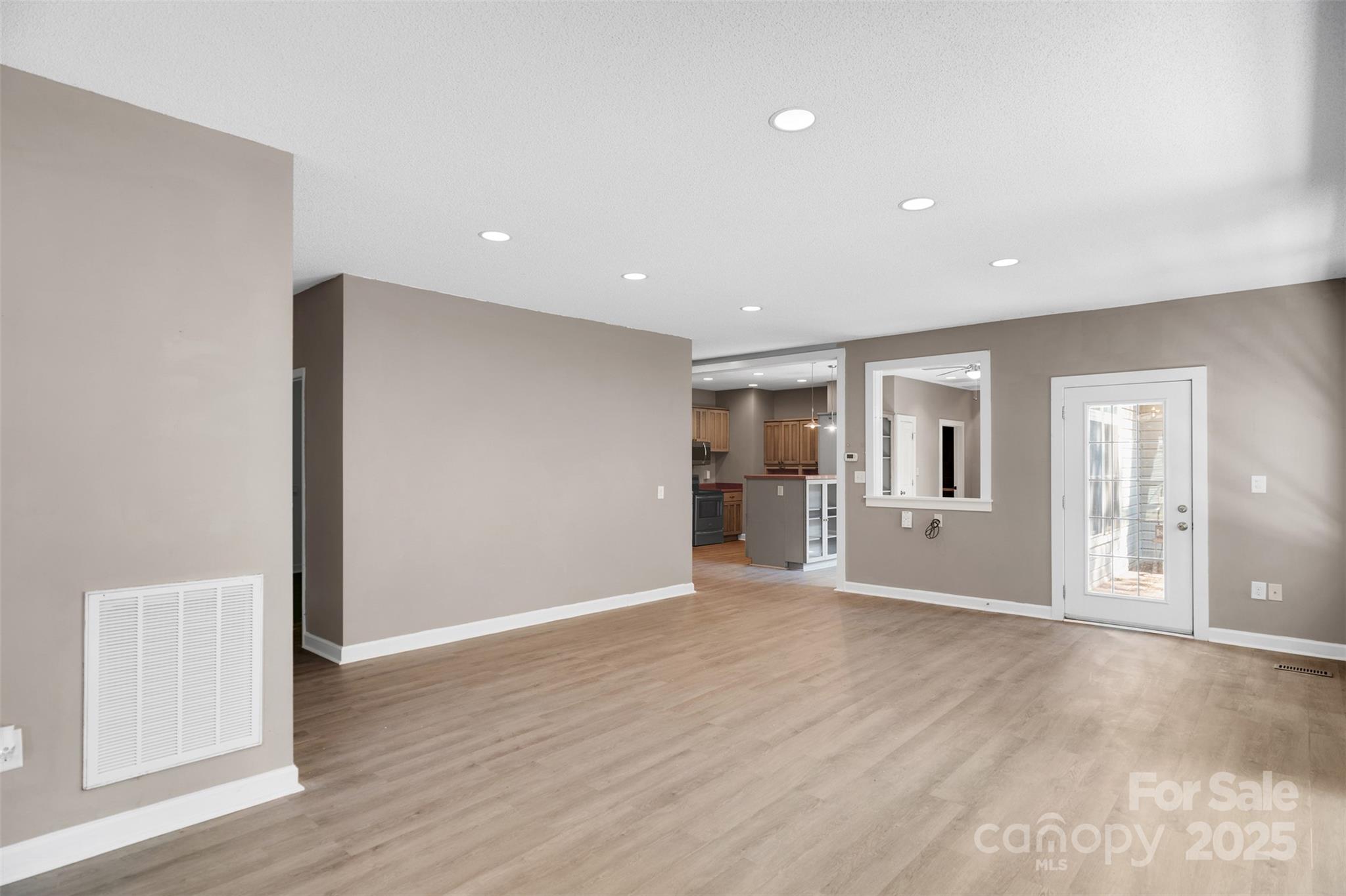 3333 Roberta Road Concord, NC 28027 - Photo 9 of 47 a view of an empty room with wooden floor and a window