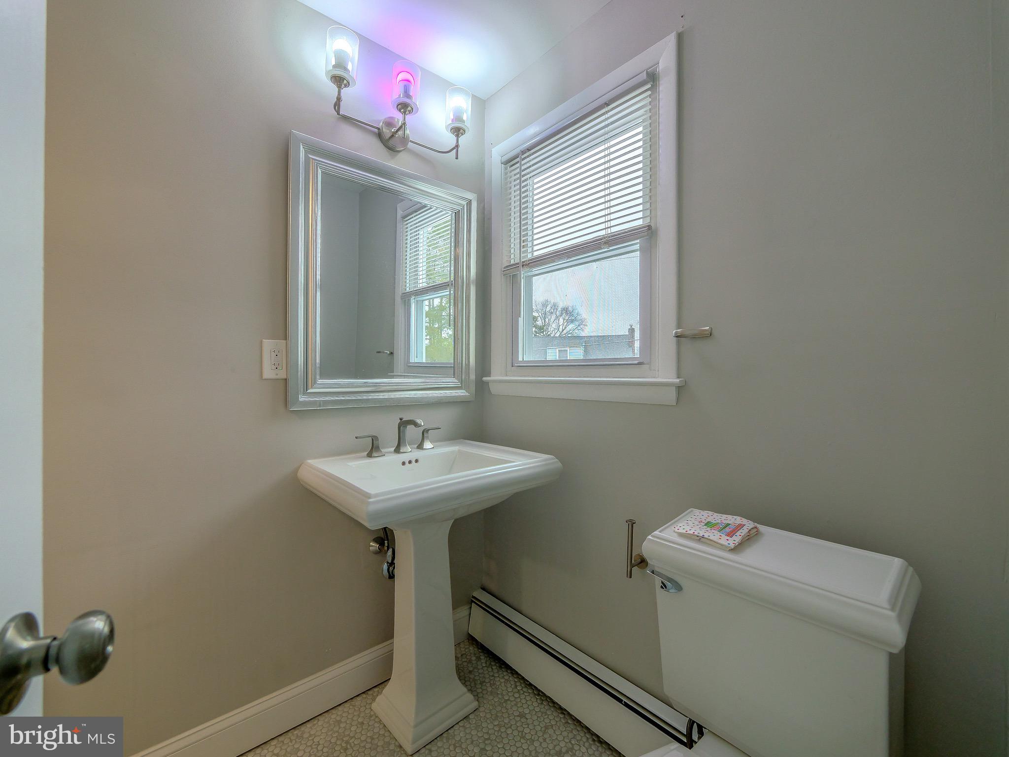520 Lindsay Street Ridley Park, PA 19078 - Photo 32 of 53 a bathroom with a sink toilet and mirror