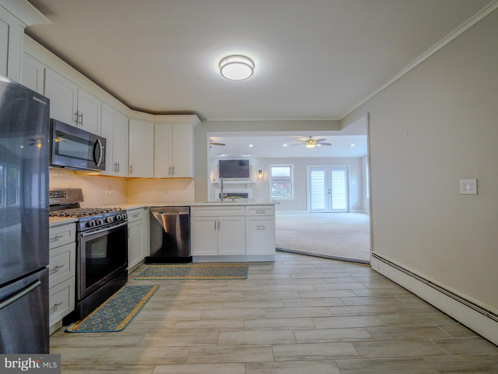 520 Lindsay Street Ridley Park, PA 19078 - Photo 7 of 53 a large kitchen with a stove a sink dishwasher a refrigerator and wooden floor