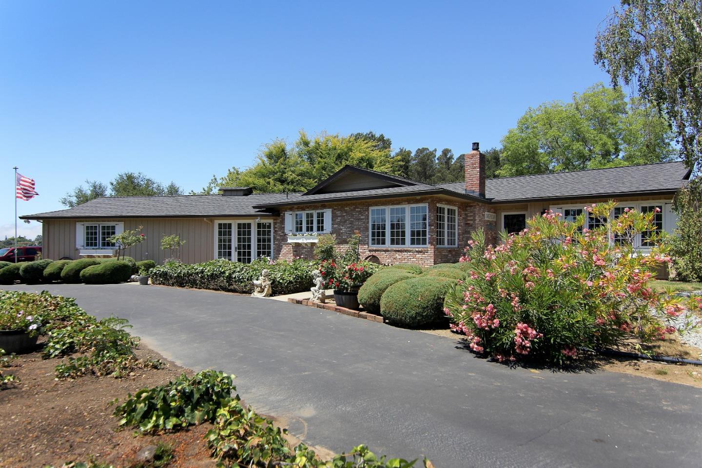 155 Wheelock Road Watsonville, CA 95076 - Photo 1 of 36 a front view of a house with a garden