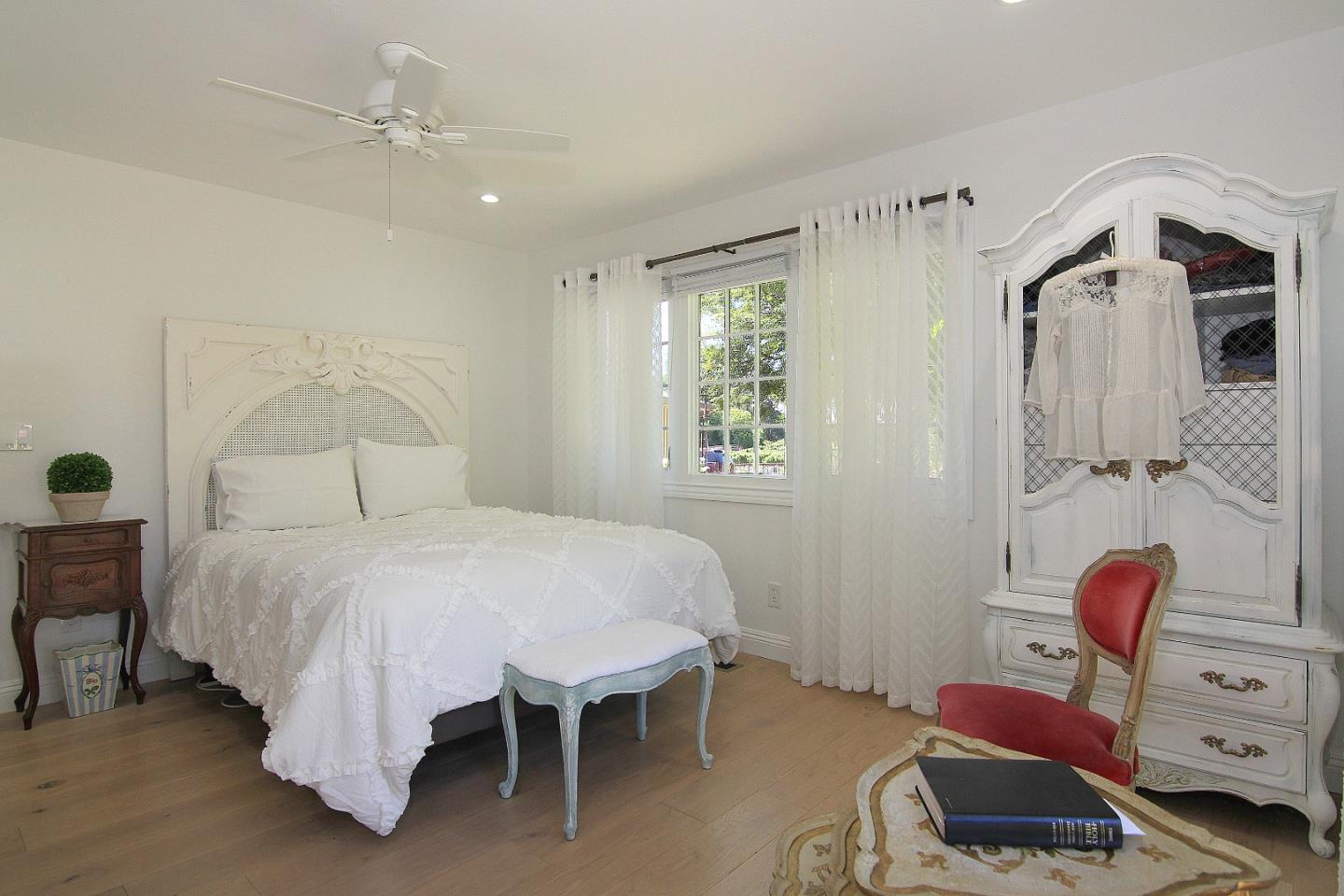 155 Wheelock Road Watsonville, CA 95076 - Photo 16 of 36 a bedroom with a bed and a chandelier