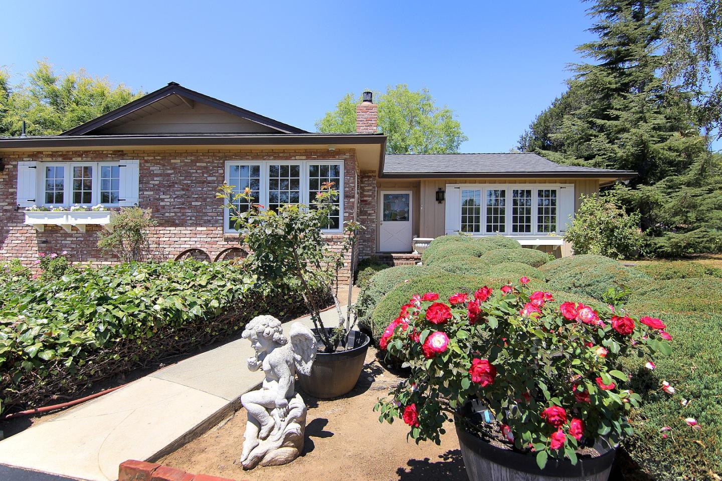 155 Wheelock Road Watsonville, CA 95076 - Photo 2 of 36 a front view of a house with a yard and fountain