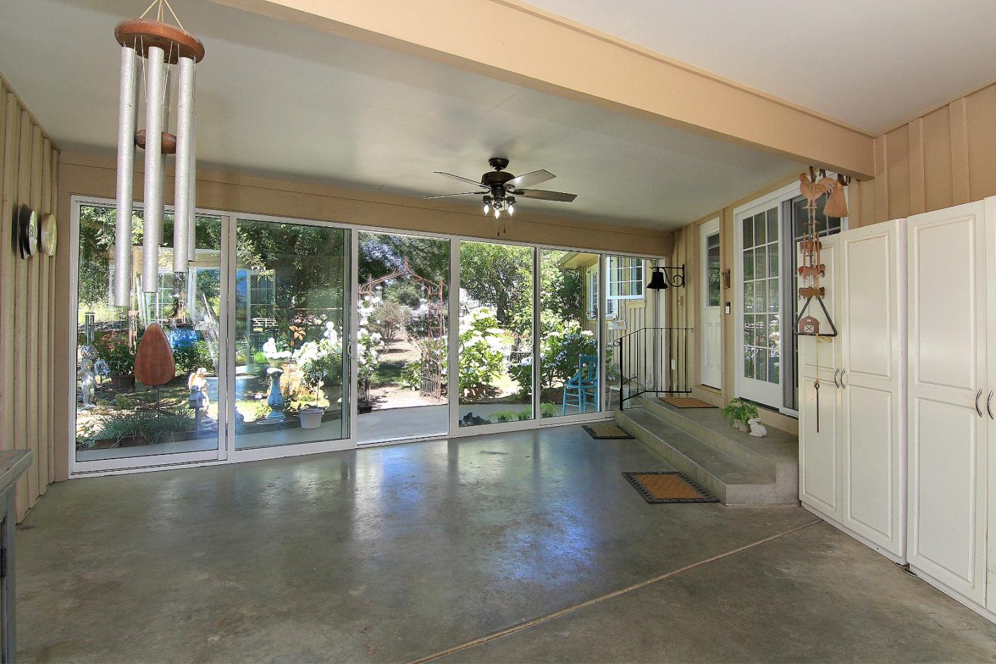 155 Wheelock Road Watsonville, CA 95076 - Photo 24 of 36 a view of a livingroom with wooden floor a ceiling fan and windows