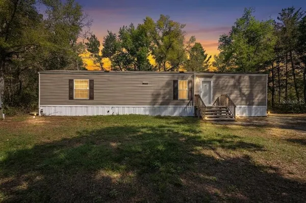 a view of backyard with wooden fence