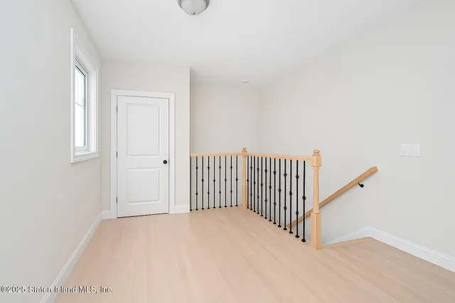 a view of a room with wooden floor