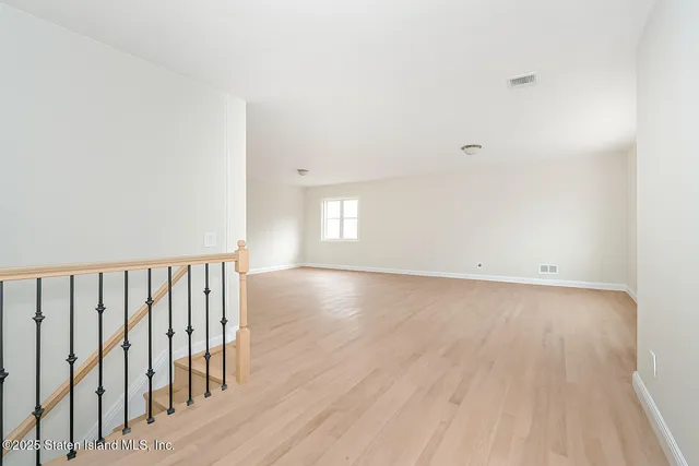 a view of wooden floor and windows in a room