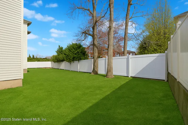 a view of an house with backyard space and garden