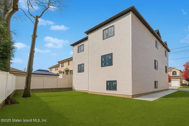 a view of a backyard with plants and a patio