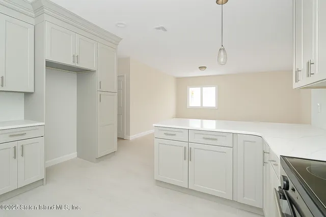 a kitchen with cabinets appliances and a window