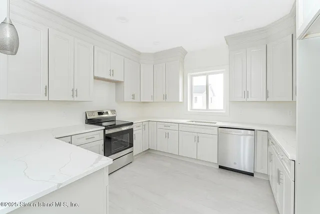 a kitchen with granite countertop white cabinets and white appliances