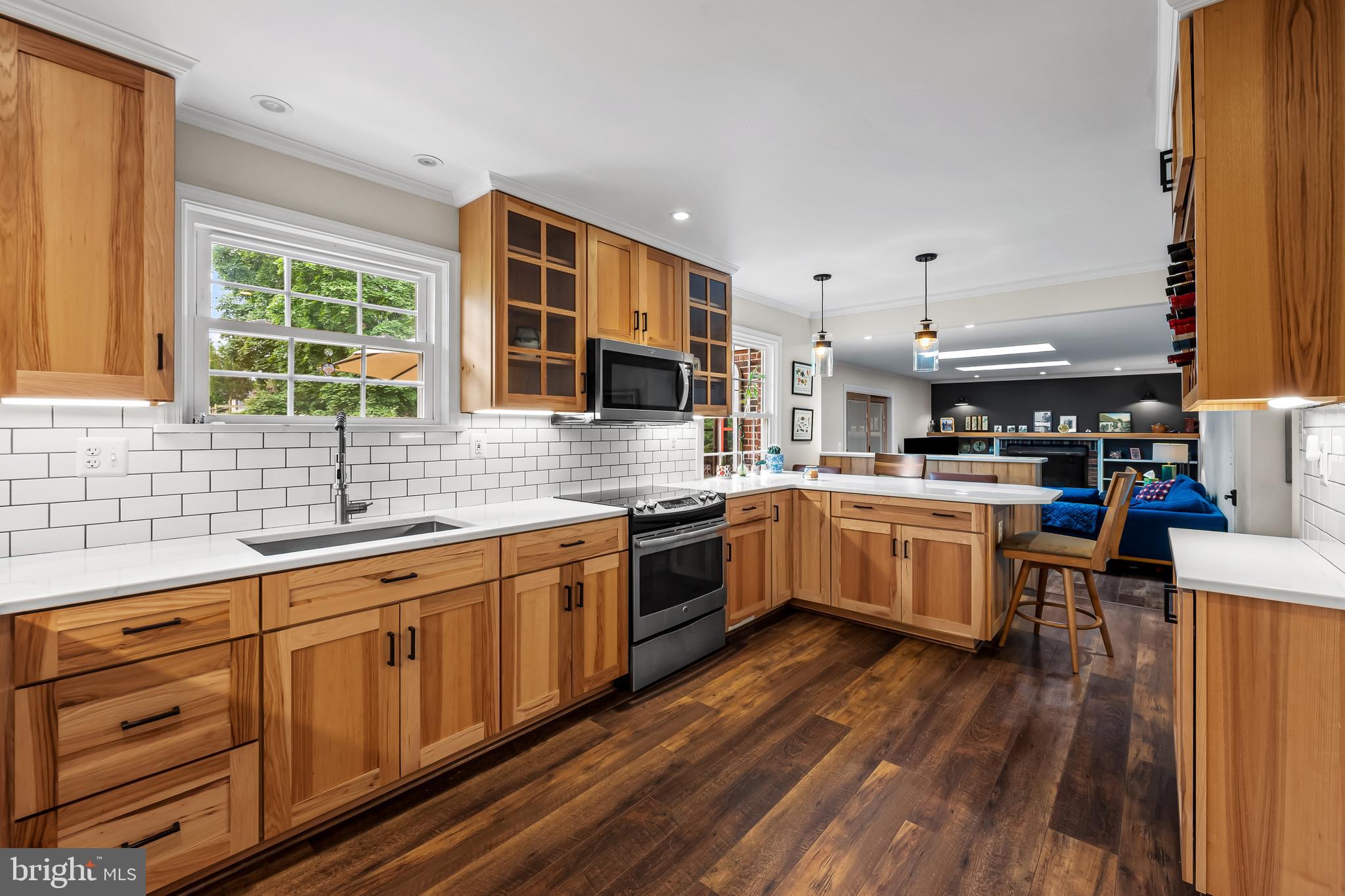 17 Sunnyview Drive Phoenix, MD 21131 - Photo 12 of 48 a kitchen with stainless steel appliances kitchen island granite countertop a stove a sink and white cabinets