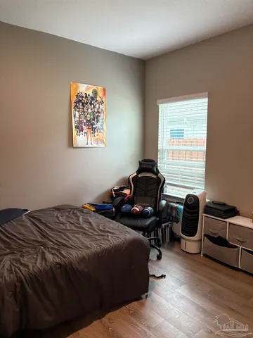 a bedroom with a bed and a chair