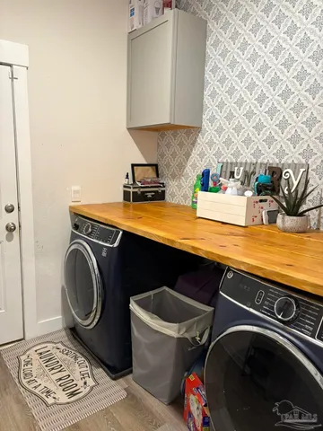 a utility room with sink dryer and washer