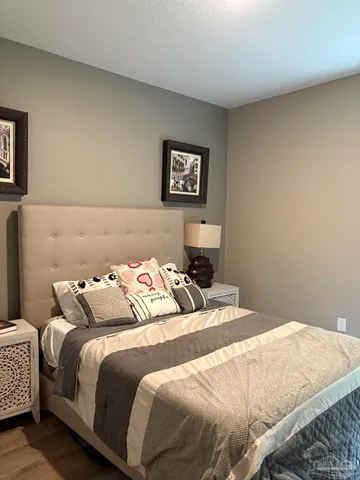 a bedroom with a bed and a lamp