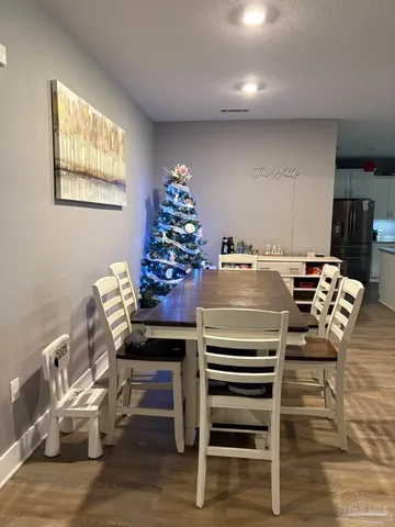 a view of a dining room with furniture and wooden floor