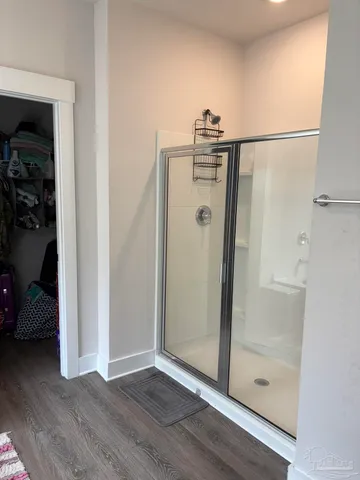 a view of water heater room with wooden floor
