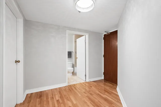 a view of a room with wooden floor and bathroom