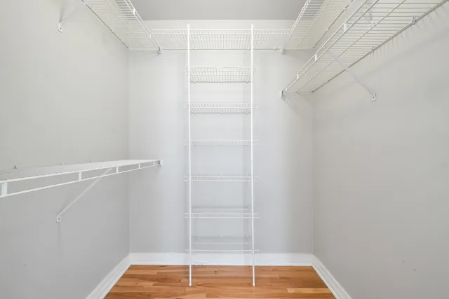 a view of walk in closet with empty racks