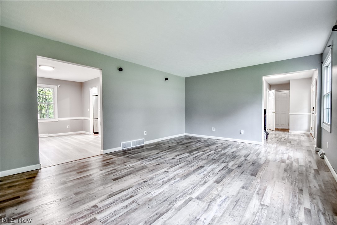 8242 Starburst Road Mentor, OH 44060 - Photo 29 of 37 Expansive main living area featuring wood-finish flooring, light gray wall paint, and white trim