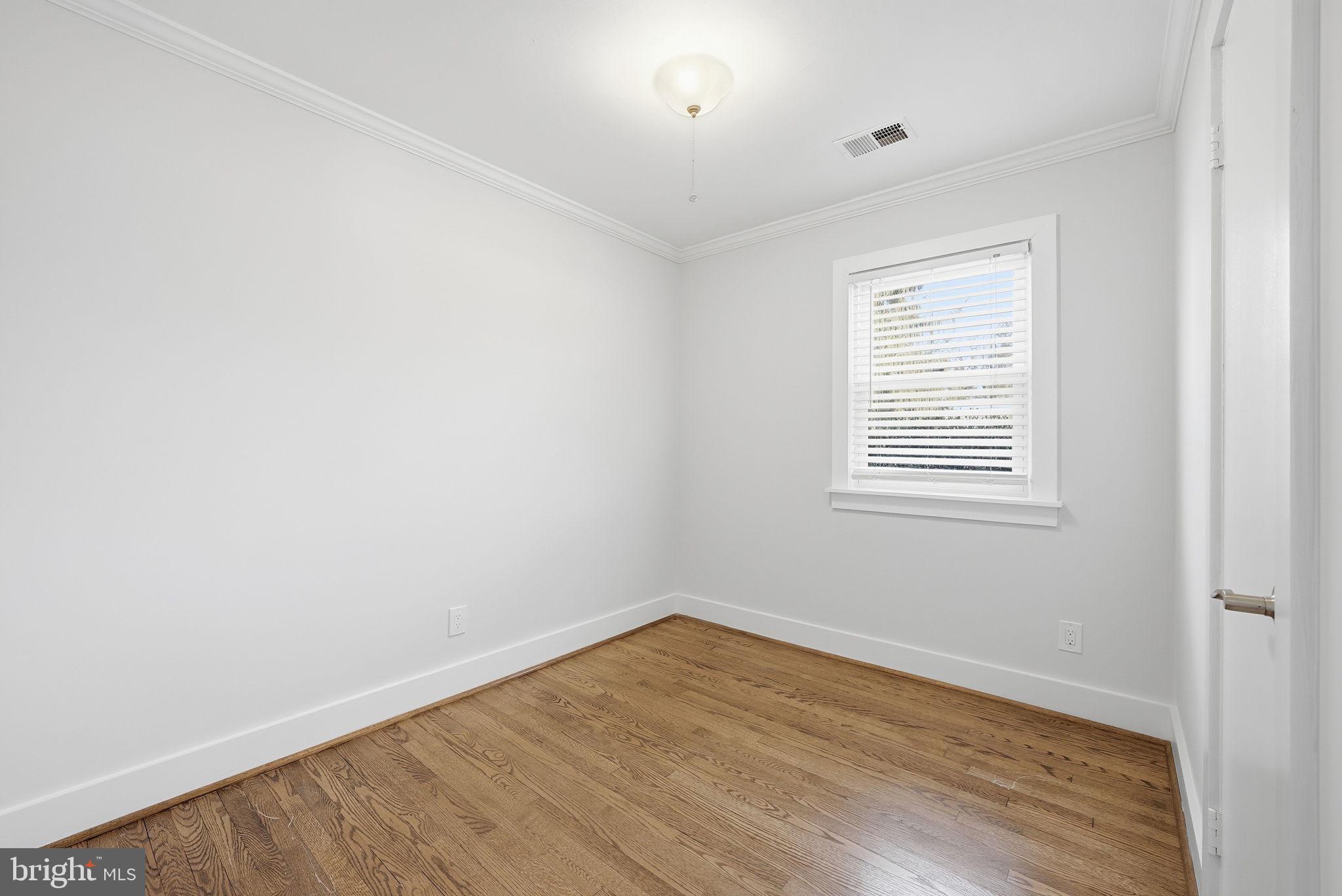 17509 Black Rock Road Germantown, MD 20874 - Photo 13 of 26 an empty room with wooden floor and windows