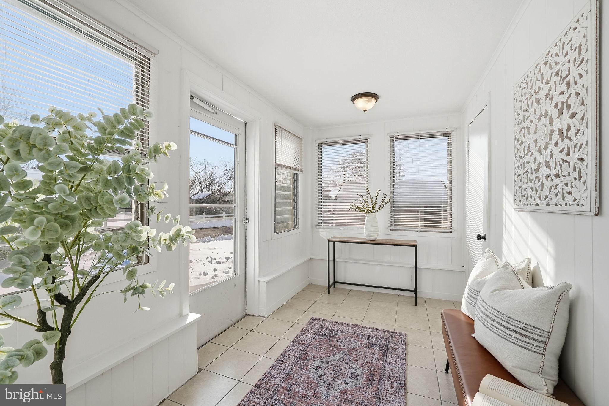 17509 Black Rock Road Germantown, MD 20874 - Photo 9 of 26 a spacious bedroom with a balcony a bed and a couch next to a window