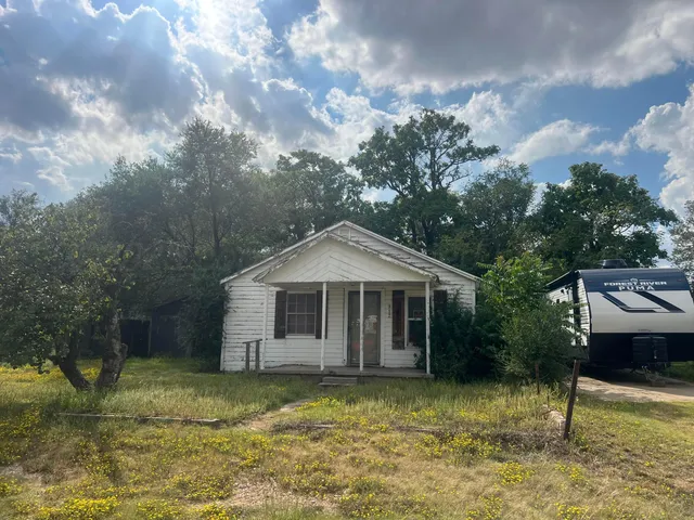 a front view of a house with a yard garage and outdoor seating