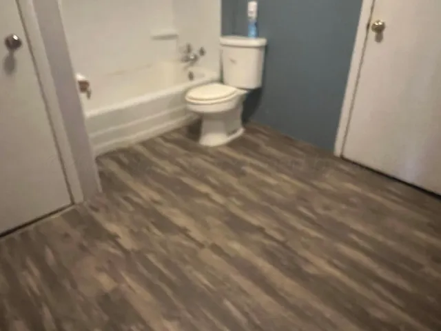 a bathroom with a toilet and a shower