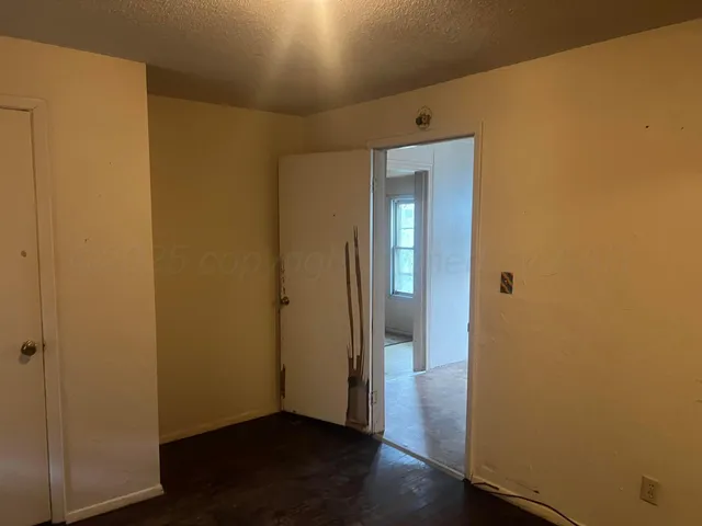 an empty room with wooden floor