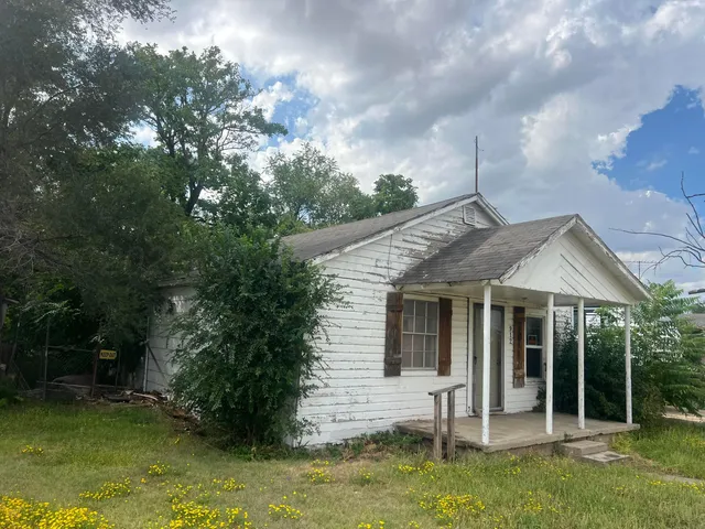 a backyard of a house with yard barbeque oven and outdoor seating