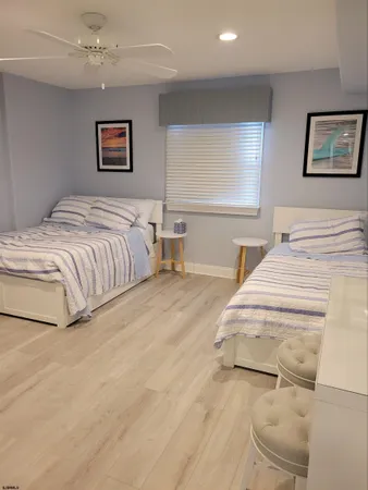 a spacious bedroom with a bed and painting on the wall